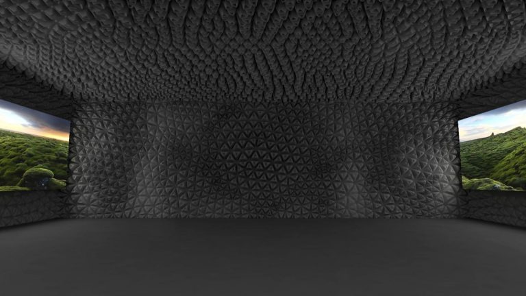 Immersive room with faceted black textured walls and landscape projections.