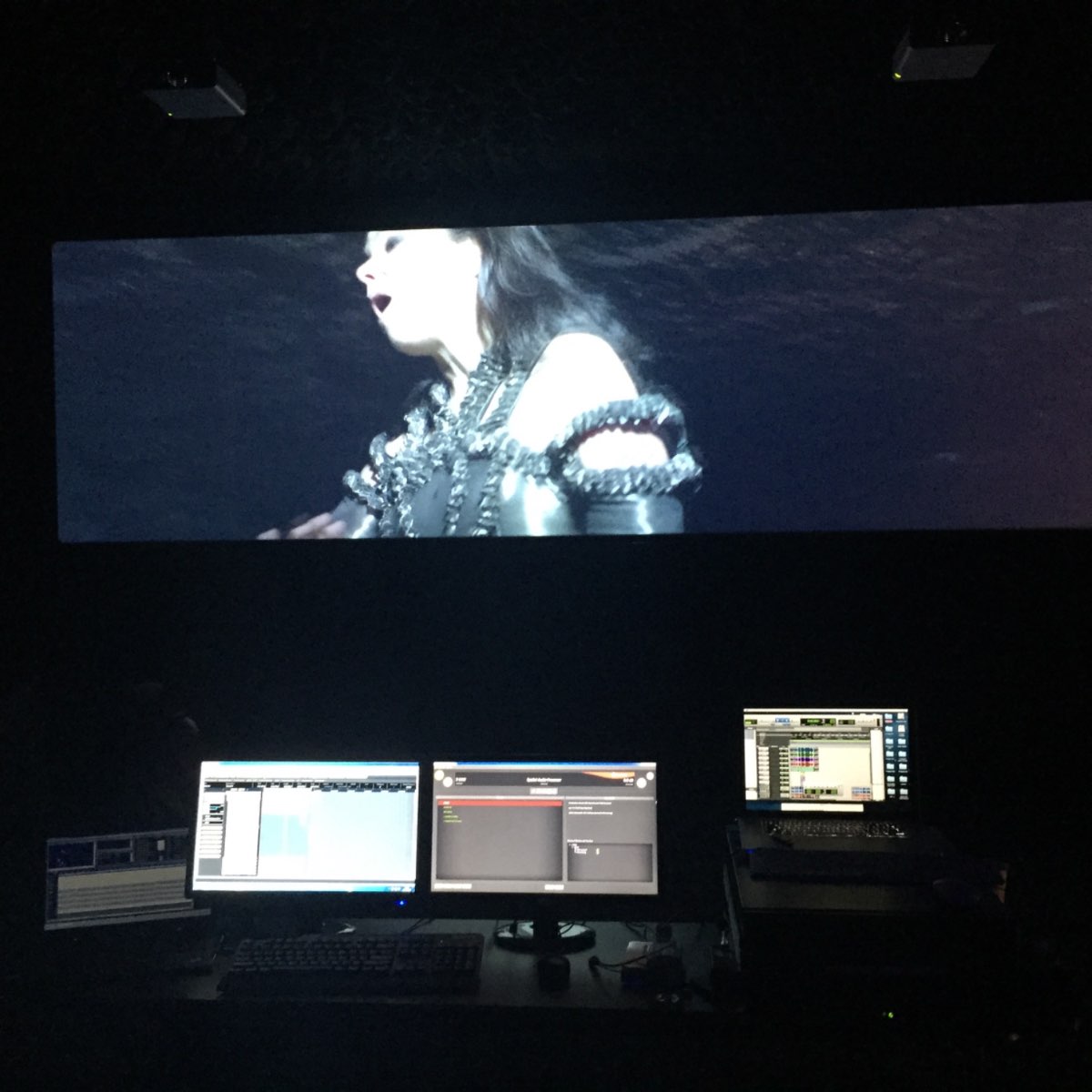 Black Lake control room at MoMA — Björk on a wide projection screen above a spatial-audio mixing desk.