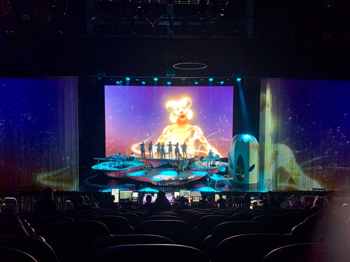 Björk performing Cornucopia on a stage wrapped in projection.
