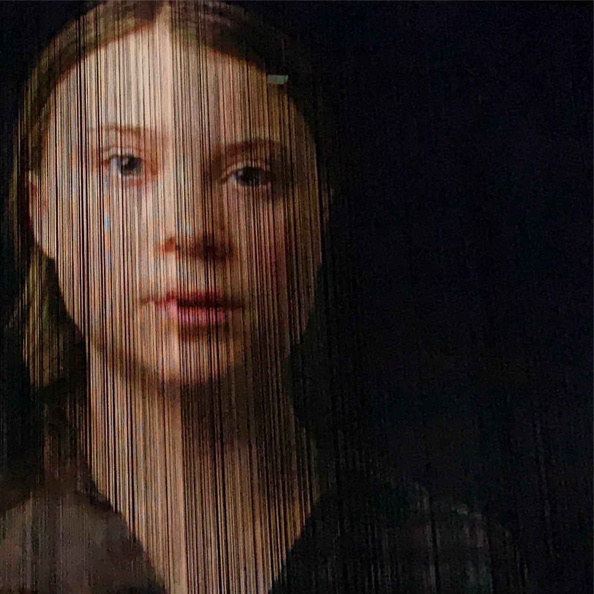 A face projected onto hanging strings at the Cornucopia show.