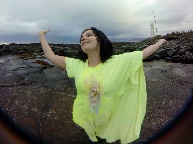 Björk with arms raised on the shoreline, a Stonemilker VR still.