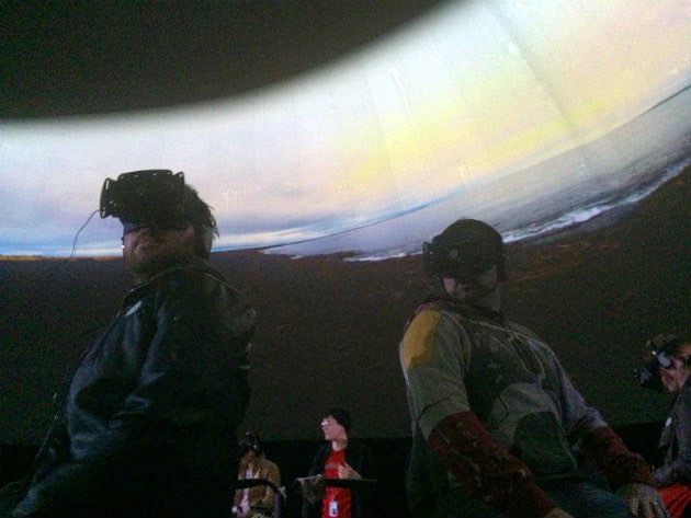 Visitors in VR headsets inside the projection dome at MoMA PS1.