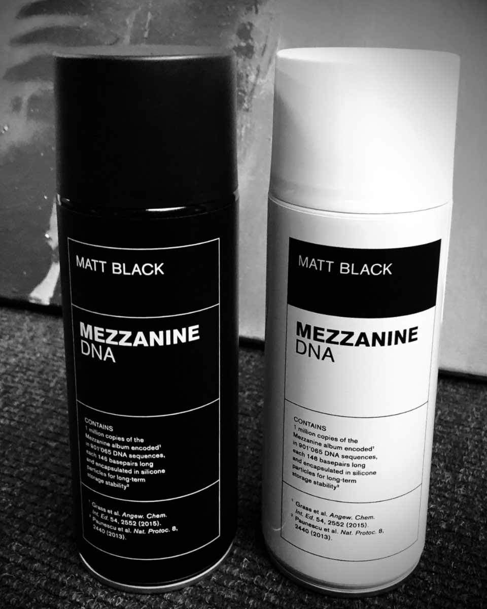 Two spray cans holding Massive Attack's Mezzanine encoded into synthetic DNA.