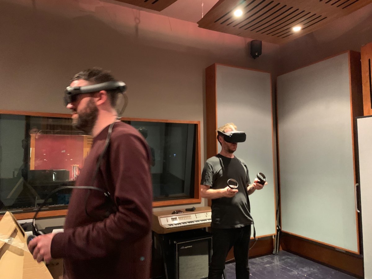 A collaborator wearing a VR headset in the recording studio.