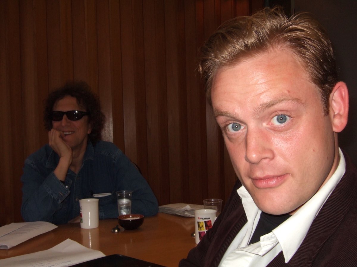 Mick Rock and Andrew Melchior at a table with coffee.
