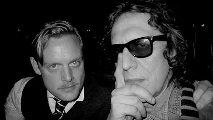 Black-and-white portrait of Andrew Melchior and Mick Rock.