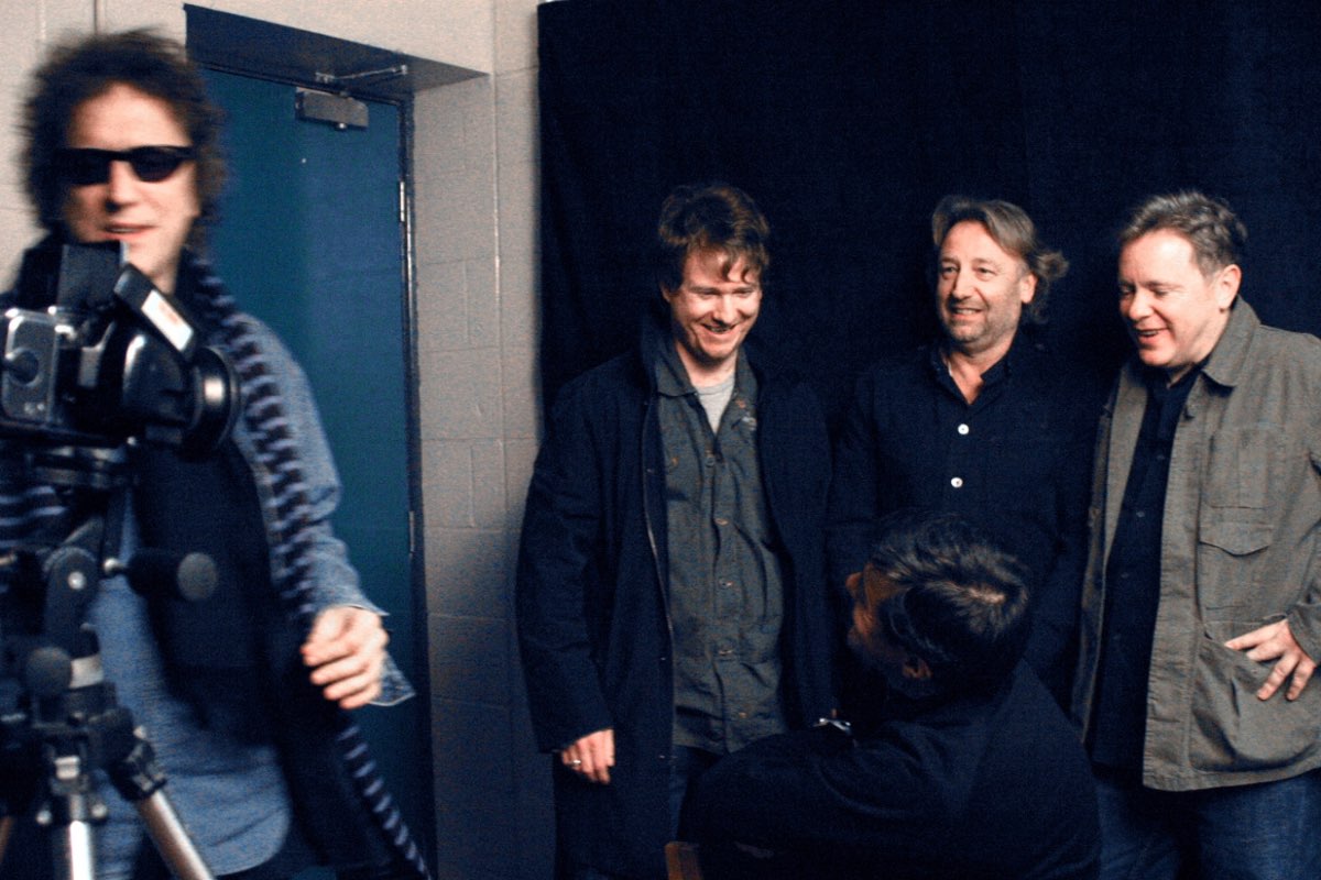 Mick Rock with a Hasselblad photographing New Order backstage.