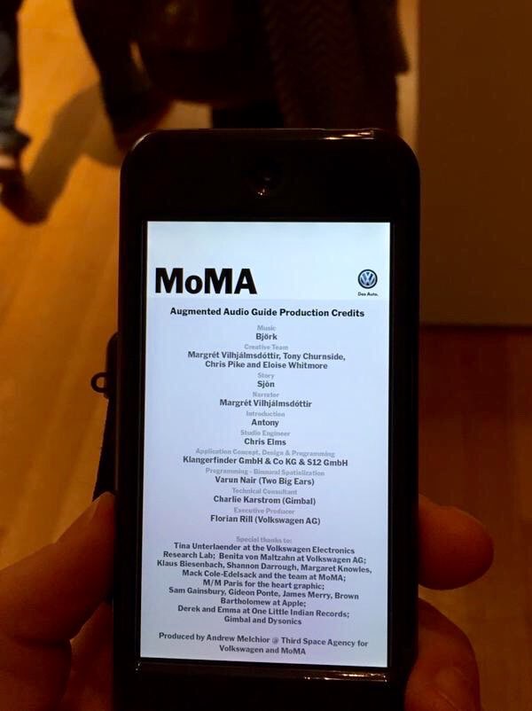 An iPhone showing the MoMA Augmented Audio Guide production credits, produced by Andrew Melchior.